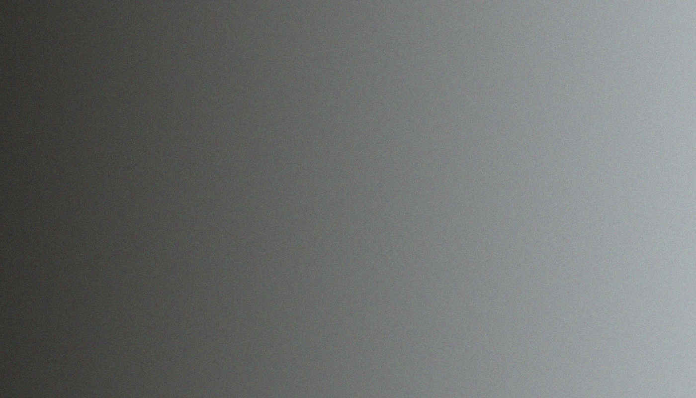 A gradient background transitioning from dark grey on the left to light grey on the right.