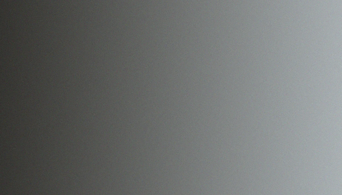 A gradient background transitioning from black on the left to light gray on the right.